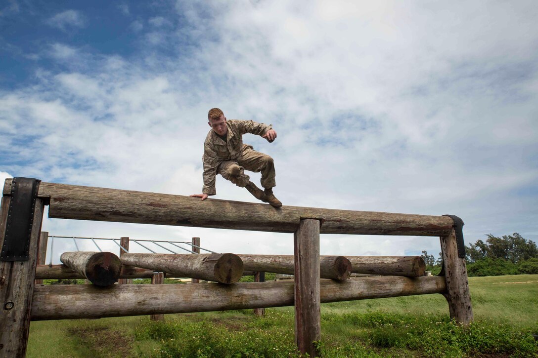 Pfc. Carlton Fyfee, a rifleman with Bravo Company, 1st Battalion, 3rd Marine Regiment and Kilgore, Texas, native, hops over a log while running through the obstacle course at Boondocker Training Area aboard Marine Corps Base Hawaii, Sept. 15, 2015. Marines from Bravo Co. 1st Bn., 3rd Marines conducted sustainment training to ensure they keep their combat mindset sharp and intact before embarking on their upcoming Unit Deployment Program. Training like this supports the mission of Marine Corps Base Hawaii by enhancing and sustaining combat readiness. (U.S. Marine Corps photo by Cpl. Brittney Vito/Released)