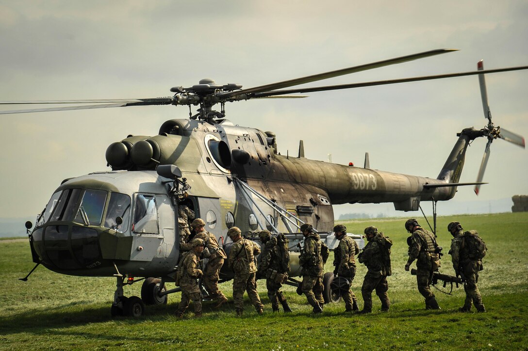 U.S. Army paratroopers and Czech army paratroopers board a Czech helicopter after an air assault exercise as part of Sky Soldier II on Bechyne Training Area in the Czech Republic, Sept. 24, 2015. Sky Soldier is a series of bilateral exercises designed to increase interoperability and strengthen partnerships between NATO airborne forces. The U.S. paratroopers are assigned to the 1st Squadron, 91st Cavalry Regiment, 173rd Airborne Brigade. U.S. Army photo by Markus Rauchenberger