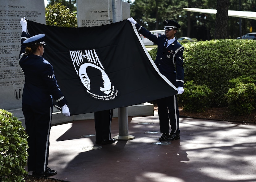 Hurlburt Field Honor Guard members unfold a POW/MIA flag during a remembrance ceremony on Hurlburt Field, Fla., Sept. 17, 2015. Annually, Hurlburt Field pays tribute to POWs and those who are MIA during the ceremony, followed by a 24-hour ruck march and run. (U.S. Air Force photo by Senior Airman Jeff Parkinson)