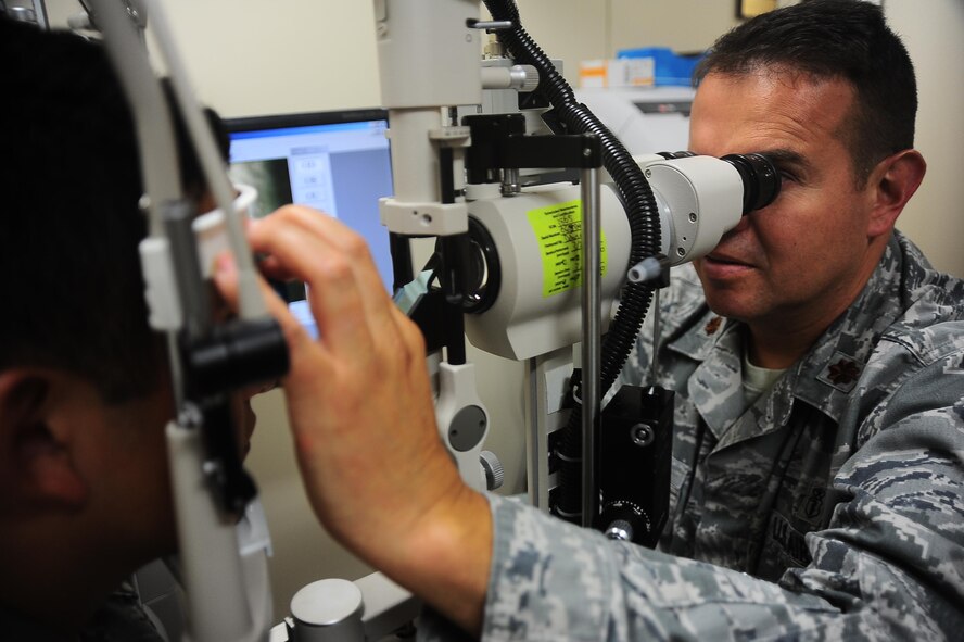 Maj. Oscar Corredor, Aerospace Medicine Flight Commander, exams a patients eye Sept. 22 at the Columbus Air Force Base medical clinic. The optometry clinic is well equipped with the latest technology to fully assess the health of the visual system. (U.S. Air Force photo/Airman 1st Class Daniel Lile)