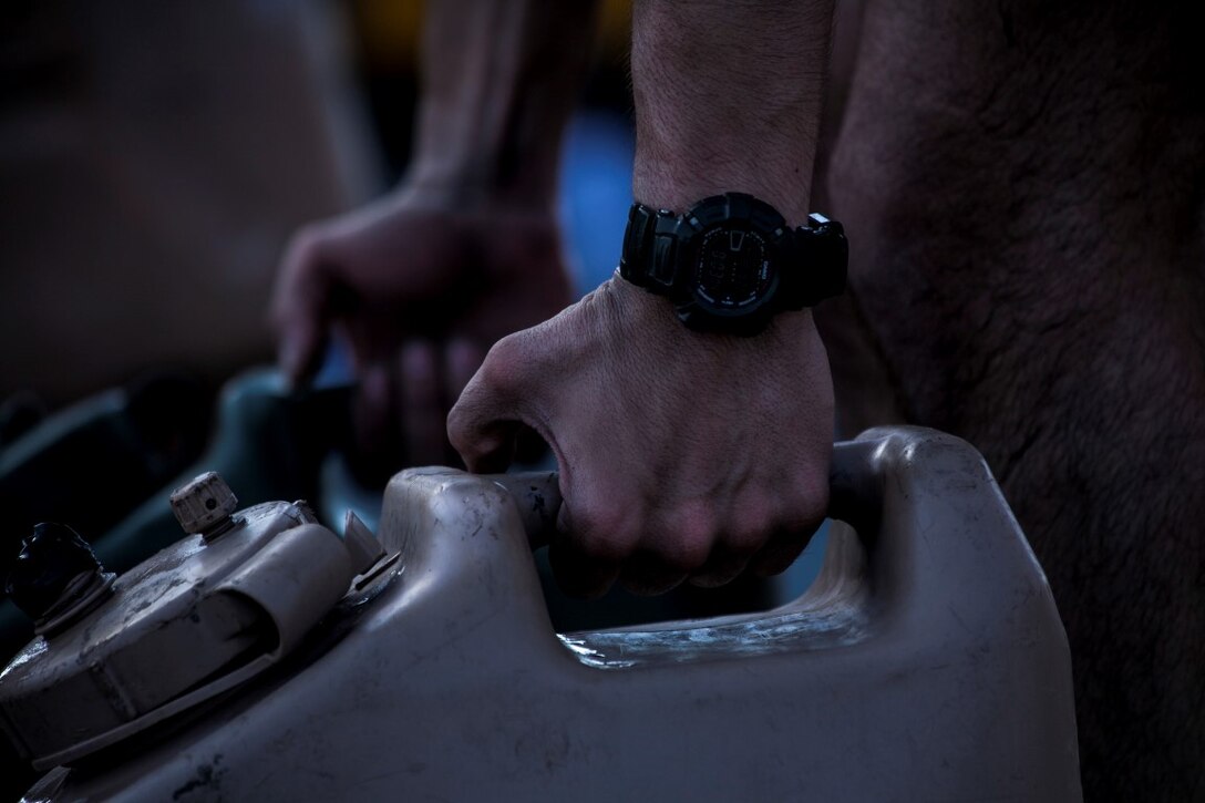 ARABIAN GULF (Sept. 22, 2015) A U.S. Marine with the 15th Marine Expeditionary Unit carries water jugs during physical training on the flight deck of the amphibious assault ship USS Essex (LHD 2). The Marines are attending a corporals course which prepares them to be successful noncommissioned officers. The 15th MEU, embarked aboard the ships of the Essex Amphibious Ready Group, is deployed to maintain regional security in the U.S. 5th Fleet area of operations. (U.S. Marine Corps photo by Cpl. Elize McKelvey/Released)