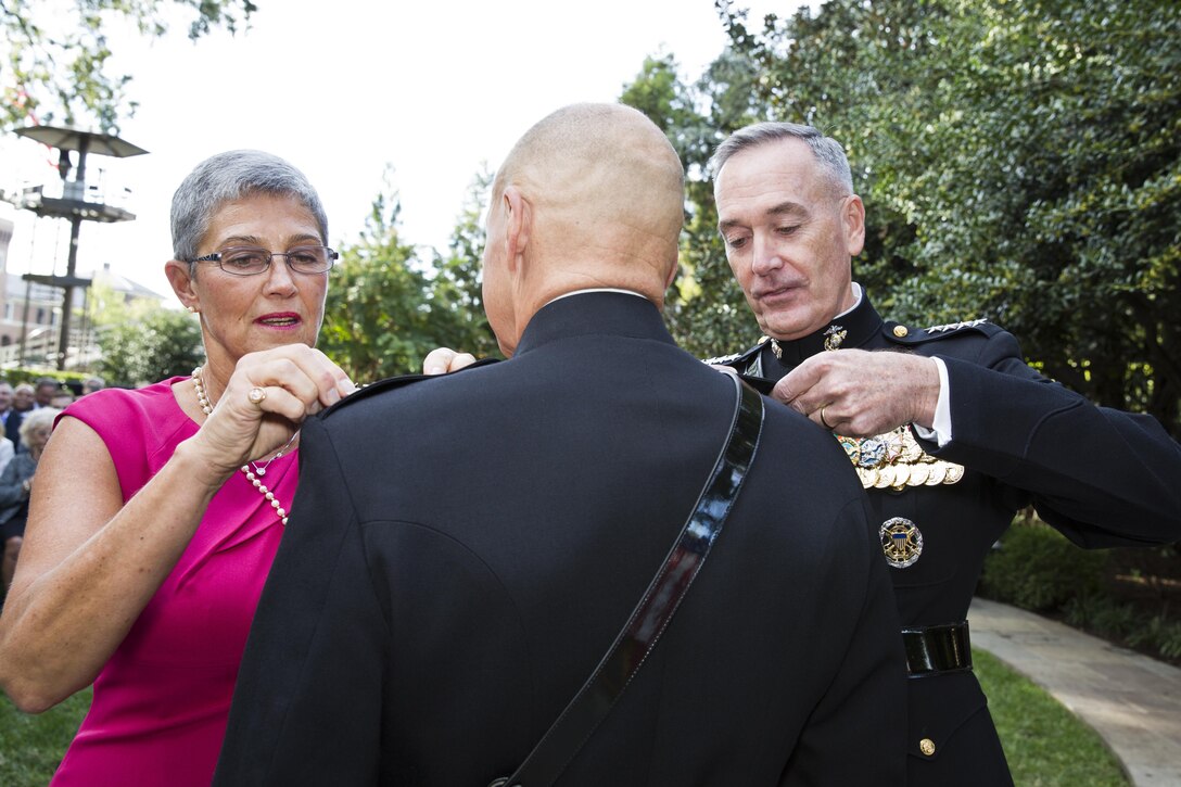 Commandant of the Marine Corps, Gen. Joseph F. Dunford, Jr., right, and Darcy Neller, left, pin four stars on Gen. Robert B. Neller’s uniform during his promotion ceremony at Marine Barracks Washington, D.C., Sept. 24, 2015. Neller was promoted from the rank of lieutenant general to general in the Marine Corps. (U.S. Marine Corps photo by Sgt. Gabriela Garcia/Released)