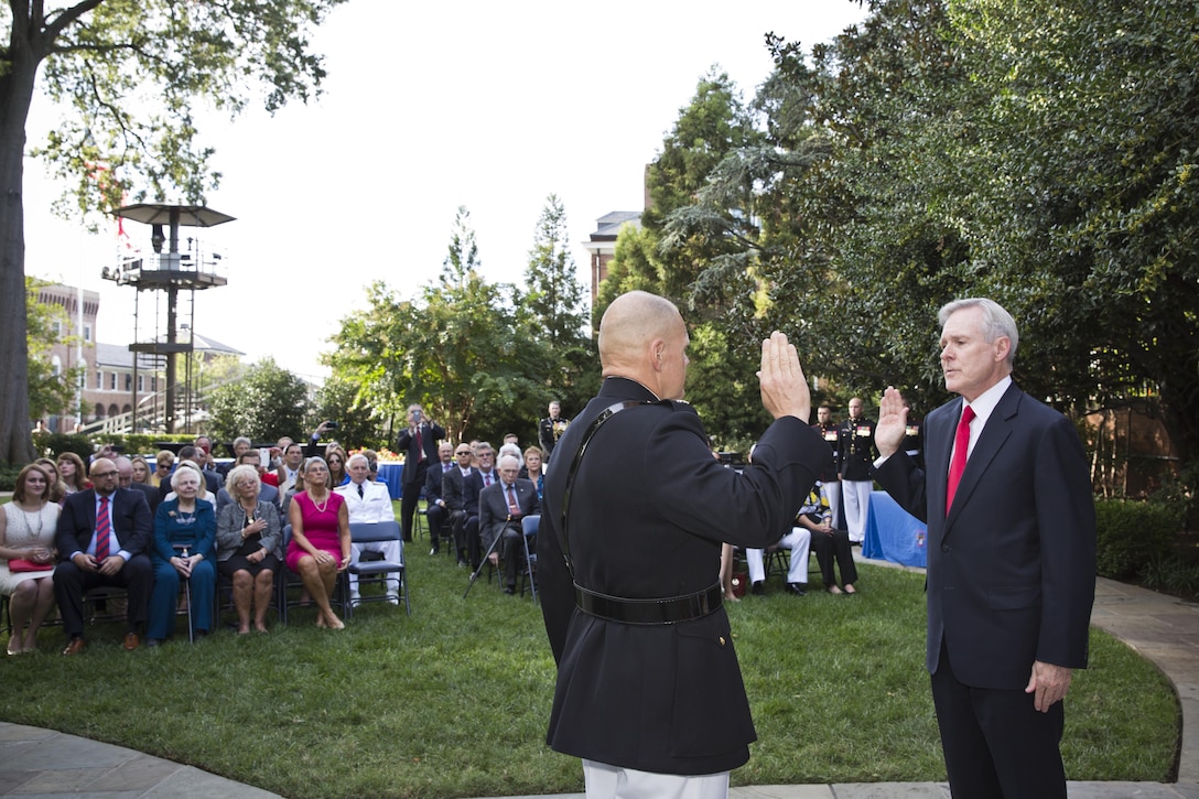 Secretary of the Navy, Raymond Edwin "Ray" Mabus, Jr., right, says the oath of office to Gen. Robert B. Neller during Neller's promotion ceremony at Marine Barracks Washington, D.C., Sept. 24, 2015. Neller was promoted from the rank of lieutenant general to general in the Marine Corps. (U.S. Marine Corps photo by Sgt. Gabriela Garcia/Released)
