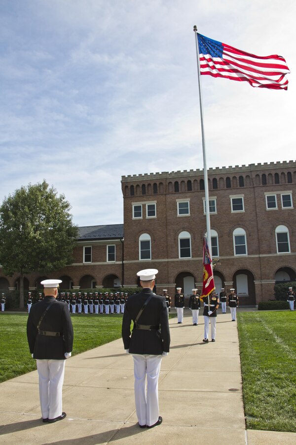 Sergeant Major of the Marine Corps Ronald L. Green, back right, walks with the Marine Corps colors towards Commandant of the Marine Corps, Gen. Joseph F. Dunford, Jr., center, and Gen. Robert B. Neller during the Passage of Command at Marine Barracks Washington, D.C., Sept. 24, 2015. Neller took command from Dunford as the 37th Commandant of the Marine Corps. (U.S. Marine Corps photo by Sgt. Gabriela Garcia/Released)
