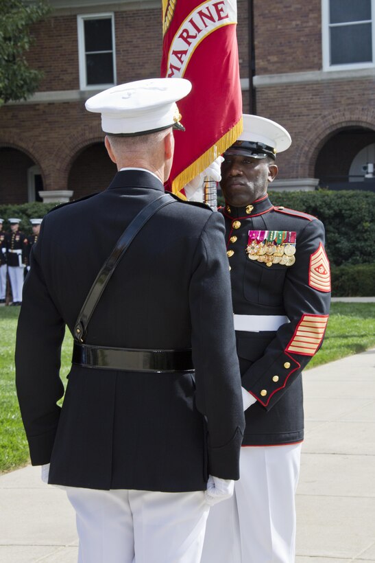 Sergeant Major of the Marine Corps Ronald L. Green, right, prepares to pass the Marine Corps colors to Commandant of the Marine Corps, Gen. Joseph F. Dunford, Jr. during the Passage of Command at Marine Barracks Washington, D.C., Sept. 24, 2015. Gen. Robert B. Neller took command from Dunford as the 37th Commandant of the Marine Corps. (U.S. Marine Corps photo by Sgt. Gabriela Garcia/Released)