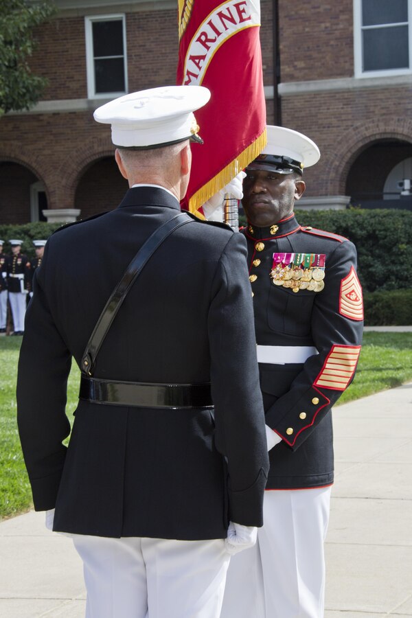 Sergeant Major of the Marine Corps Ronald L. Green, right, prepares to pass the Marine Corps colors to Commandant of the Marine Corps, Gen. Joseph F. Dunford, Jr. during the Passage of Command at Marine Barracks Washington, D.C., Sept. 24, 2015. Gen. Robert B. Neller took command from Dunford as the 37th Commandant of the Marine Corps. (U.S. Marine Corps photo by Sgt. Gabriela Garcia/Released)