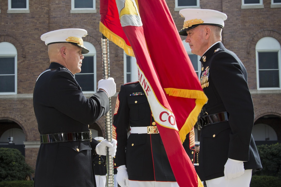 Commandant of the Marine Corps, Gen. Robert B. Neller, left, accepts the Marine Corps colors from Gen. Joseph F. Dunford, Jr., right, at Marine Barracks Washington, D.C., Sept. 24, 2015. Neller took command from Dunford as the 37th Commandant of the Marine Corps. (U.S. Marine Corps photo by Sgt. Gabriela Garcia/Released)
