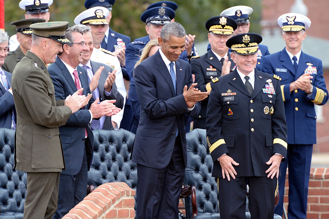 President Barack Obama, Secretary of Defense Ash Carter and Marine Gen. Joseph F. Dunford Jr., the new chairman, applaud outgoing Chairman of the Joint Chiefs of Staff Army Gen. Martin E. Dempsey during the change of responsibility ceremony at Summerall Field, Joint Base Myer-Henderson Hall, Arlington, Va., Sept. 25, 2015. DoD photo by U.S. Army Sgt. 1st Class Clydell Kinchen