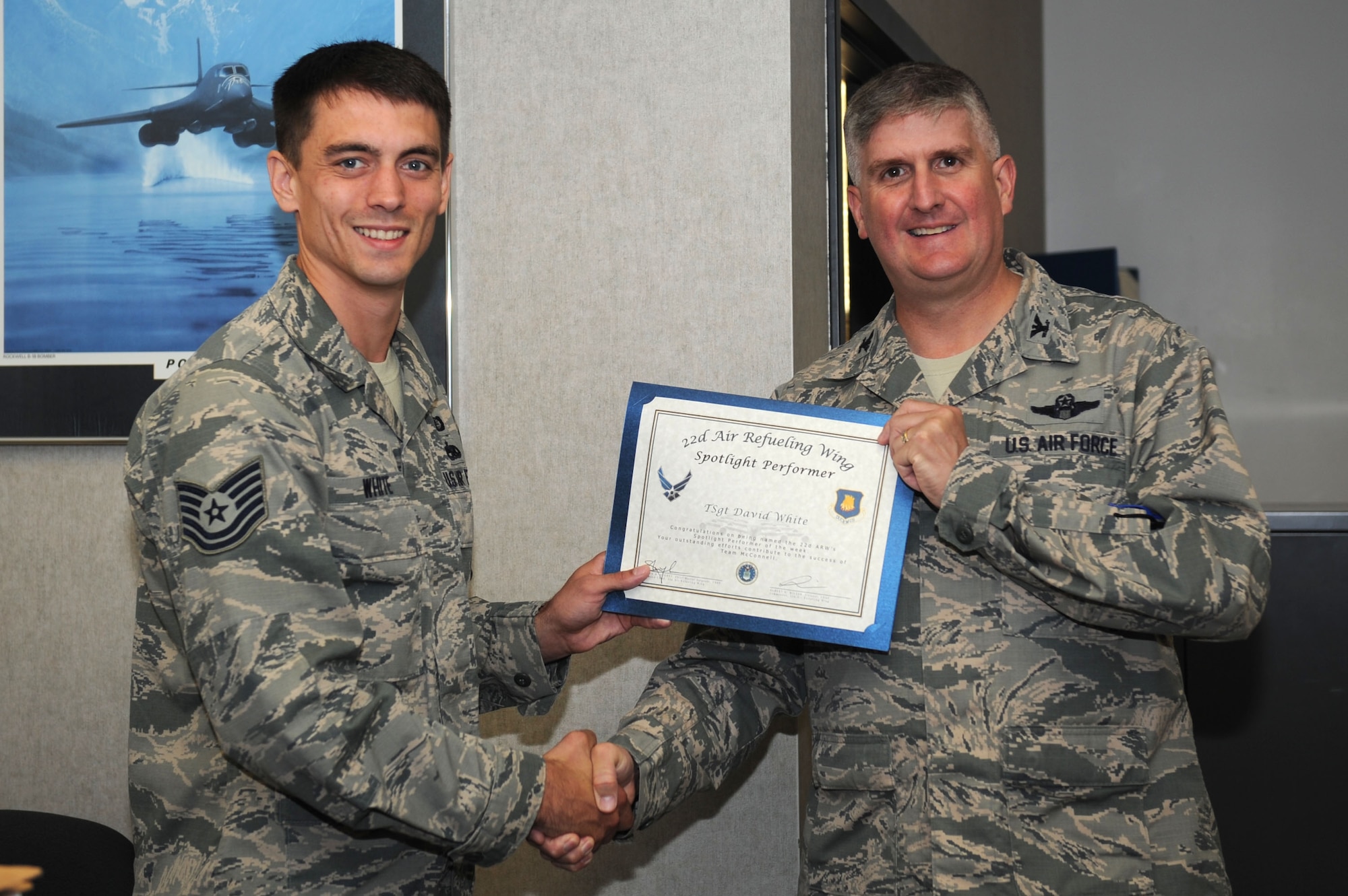 Tech. Sgt. David White, 22nd Contracting squadron services flight NCO in-charge, poses with Col. Albert Miller, 22nd Air Refueling Wing commander, Sept. 23, 2015, at McConnell Air Force Base, Kan. White was selected to be the spotlight performer for the week of Sept. 20 -26. He is responsible for the award and administration of six contracts exceeding a total value of $13 million. (U.S. Air Force photo by Airman 1st Class Tara Fadenrecht)