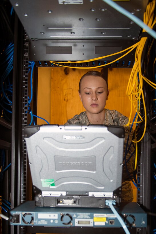 U.S. Air Force Airman Katlynn Ashby, 23d Communications Squadron network infrastructure technician, changes configuration settings on a laptop to restore network access on a PC and telephone Sept. 23, 2015, at Moody Air Force Base, Ga. Maintaining computer security is the Network Control Center’s primary mission while keeping network accessibility available for base clients. (U.S. Air Force photo by Airman 1st Class Greg Nash/Released)