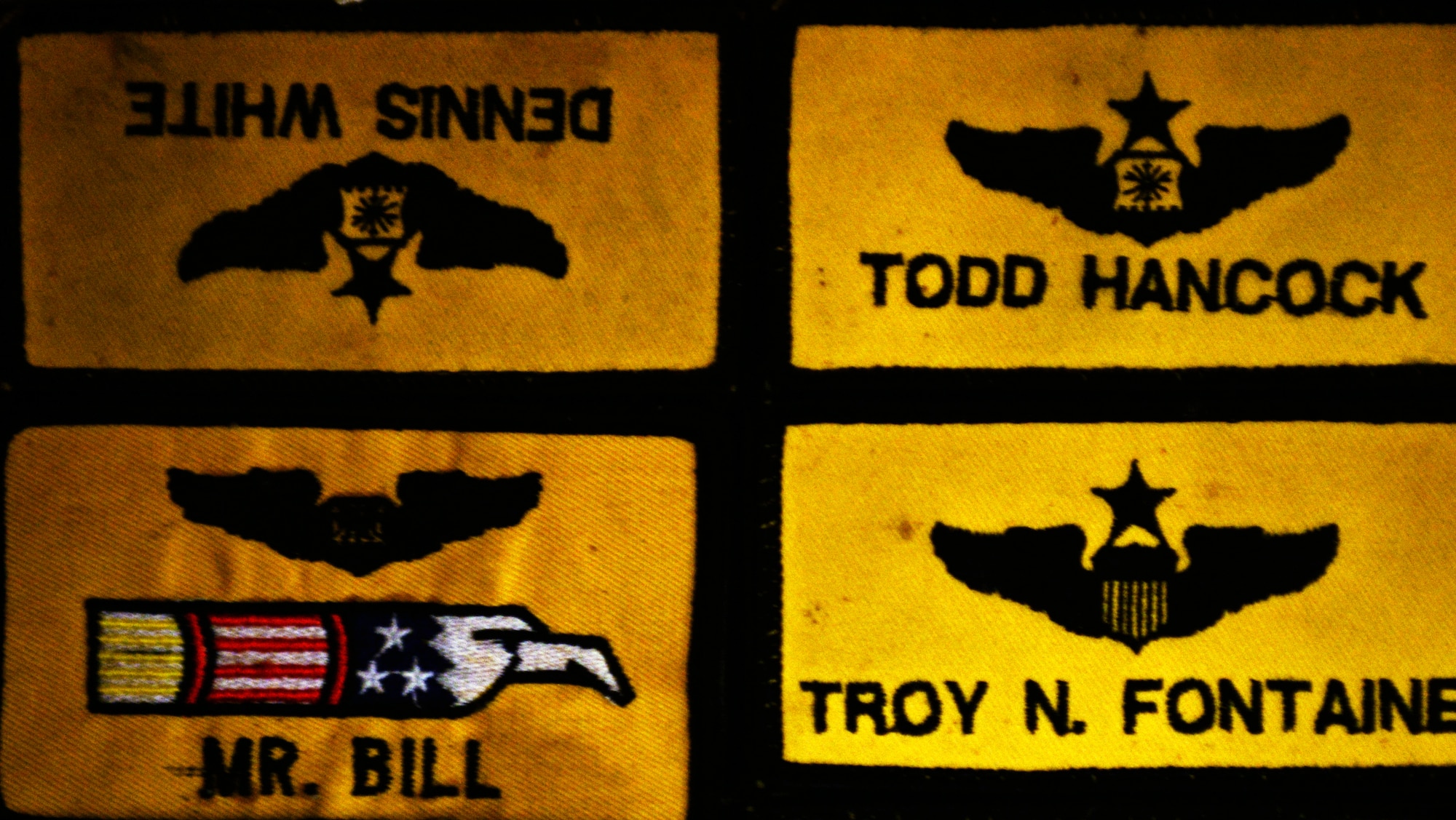 The patch of the late Capt. Dennis White, 336th Fighter Squadron weapons systems, hangs upside down on the wall of the squadron’s heritage room, Sept. 23, 2015, at Seymour Johnson Air Force Base, North Carolina. An aviator’s patch is hung upside down when the officer is killed during a flight. (U.S. Air Force photo/Airman 1st Class Ashley Williamson)