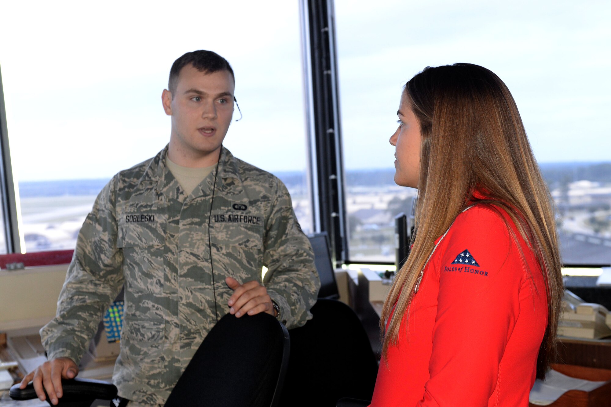 Senior Airman Tanner Sobleski, 4th Support Squadron air traffic controller, briefs Sarah White, daughter of the late Capt. Dennis White, 336th Fighter Squadron weapons systems officer, during her tour of the air traffic control tower, Sept. 23, 2015, at Seymour Johnson Air Force Base, North Carolina. Dennis accumulated more than 2,200 flying hours during his shortened career, most of which were spent as a 336th FS Rocketeer. (U.S. Air Force photo/Airman 1st Class Ashley Williamson)