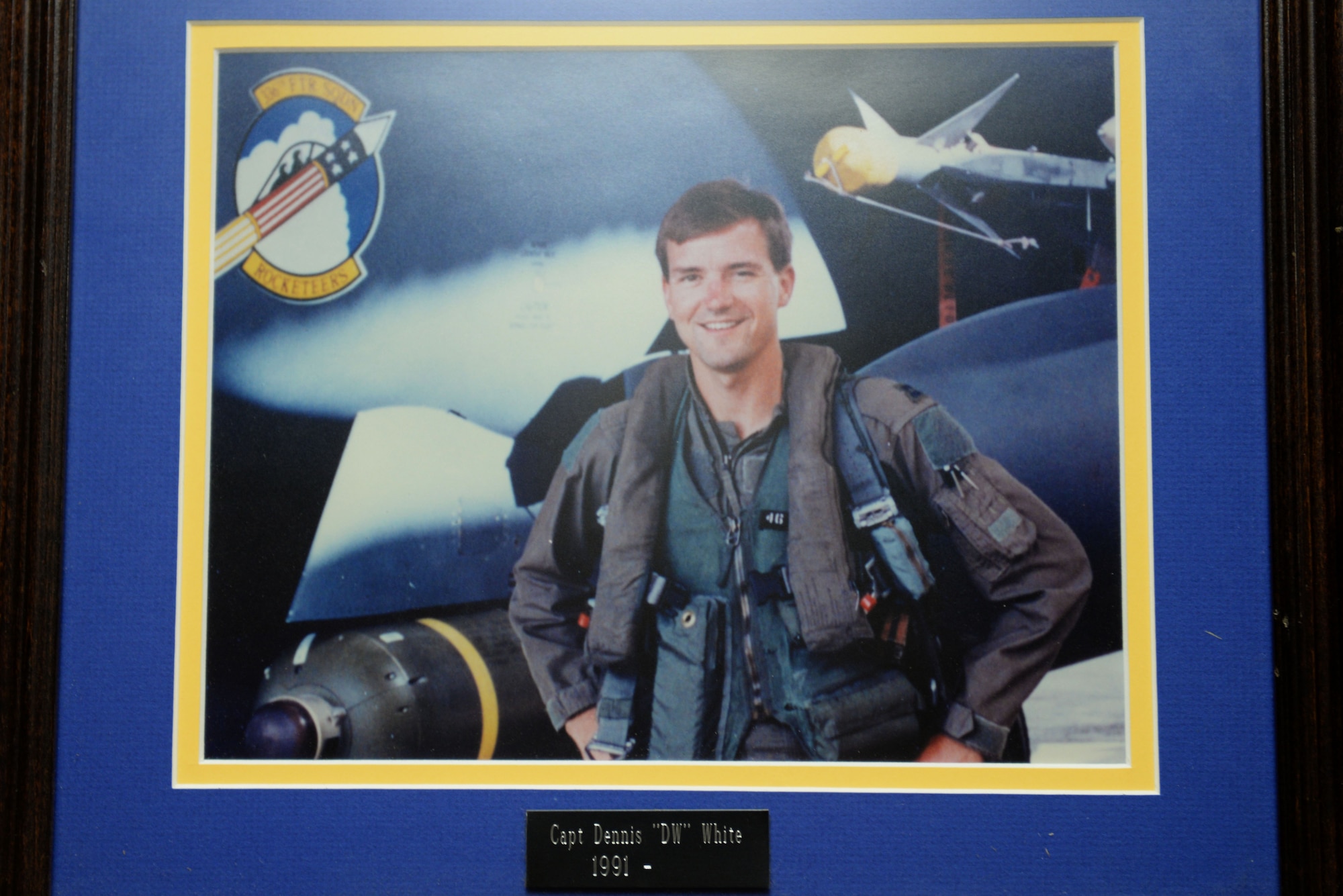 A photo of the late Capt. Dennis White, 336th Fighter Squadron weapons systems officer, hangs in the 336th FS, Sept. 23, 2015, at Seymour Johnson Air Force Base, North Carolina. White was killed April 18, 1995, after being involved in fatal air-to-air interception training exercise. (U.S. Air Force photo/Airman 1st Class Ashley Williamson)