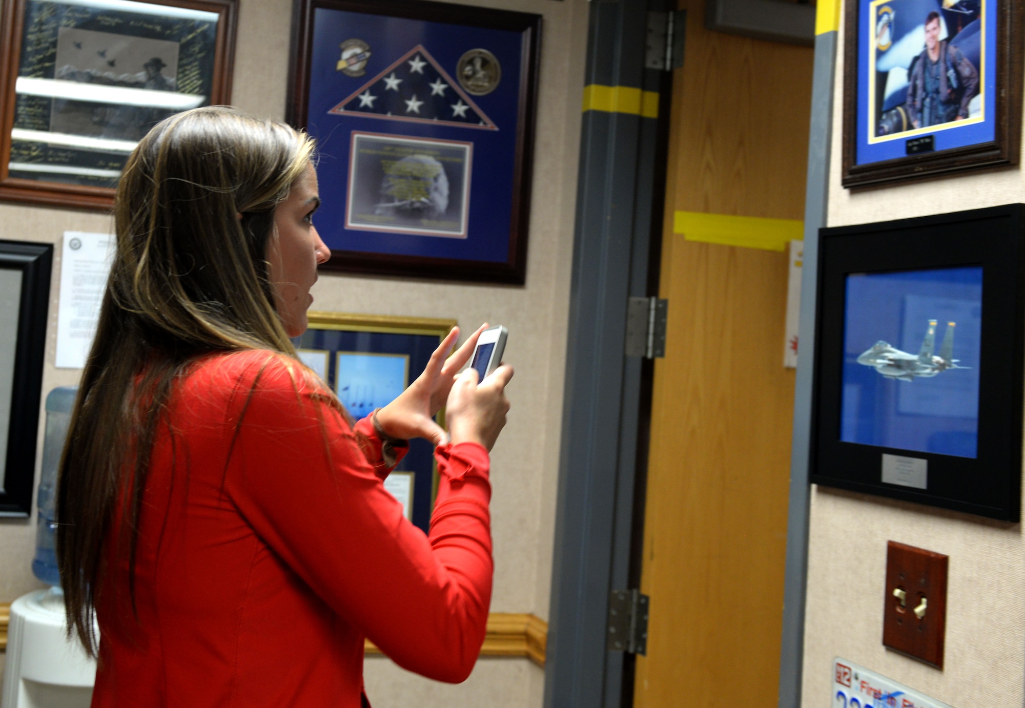 Sarah White observes a photograph of her father, the late Capt. Dennis White, 336th Fighter Squadron weapons systems officer, during her visit, Sept. 23, 2015, at Seymour Johnson Air Force Base, North Carolina. More than two decades ago, Dennis was killed during a training accident while flying a mission with the 336th FS. (U.S. Air Force photo/Airman 1st Class Ashley Williamson)