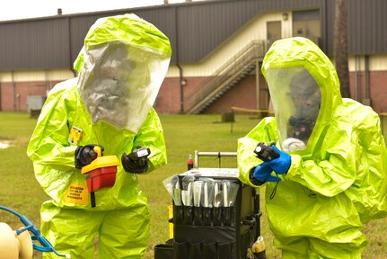 (From left to right) Senior Airman Brandon Lane, 628th Medical Group bio-environmental technician, works alongside with A1C Vanessa Ramos, 628th Civil Engineering Squadron emergency management operator, during the hazardous material exercise at Joint Base Charleston – Air Base, S.C., Sept. 25, 2015. Lane and Ramos were required to  get their vital signs checked before donning their HAZMAT suits. (U.S. Air Force photo/Airman 1st Class Thomas T. Charlton)