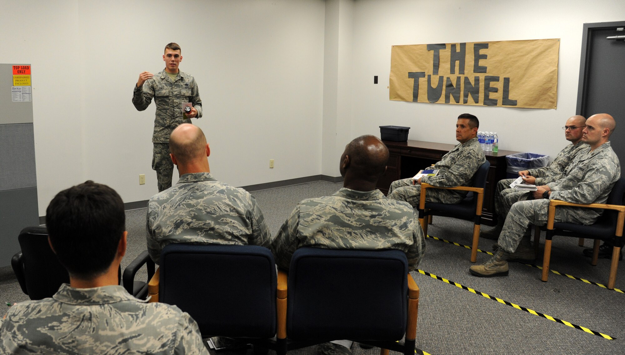 Senior Airman Tyler Jones, 319th Logistics Readiness Squadron vehicle maintenance journeyman, gives the final debrief to members of the 319th Air Base Wing leadership after they went through the Tunnel of Oppression Sept. 24, 2015, on Grand Forks Air Force Base, North Dakota. The leadership visited the Tunnel to gain a better understanding of what the Airmen experience when they participate. The Tunnel allows Airmen to speak freely about a variety of issues faced by many fellow Airmen. (U.S. Air Force photo by Airman 1st Class Ryan Sparks/Released)
