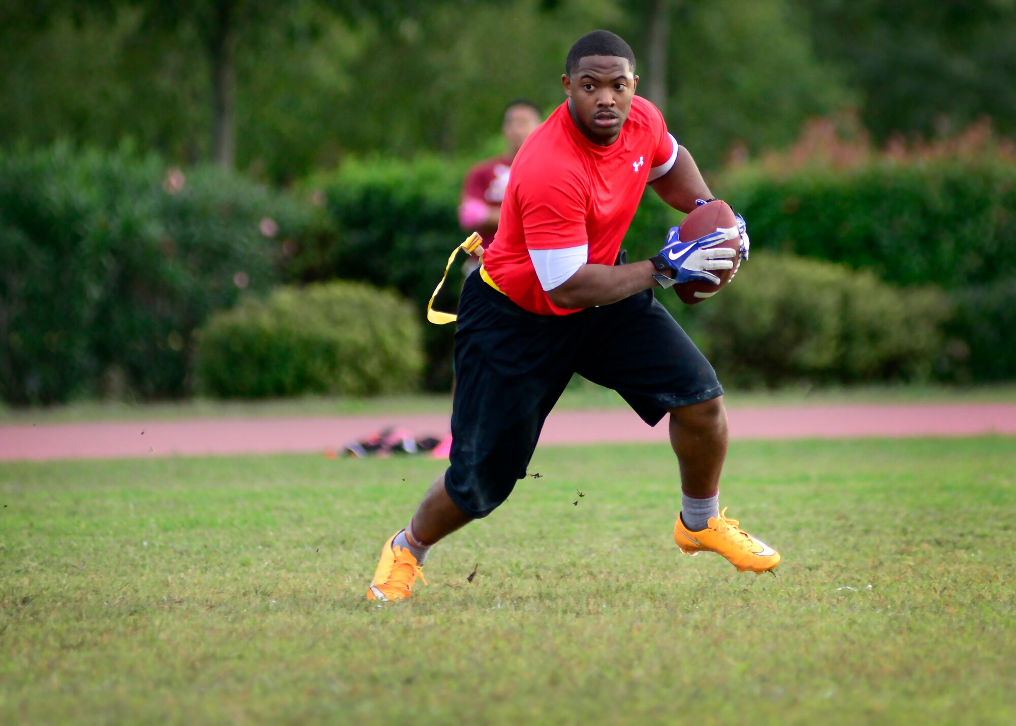 U.S. Air Force Senior Airman Kerwin Thomas, 31st Maintenance Squadron electrical and environmental journeyman, charges upfield during an intramural flag football game, Sept. 24, 2015, at Aviano Air Base, Italy. The 31st MXS defeated the 31st Communication Squadron 32-12. (U.S. Air Force photo by Senior Airman Areca T. Bell/Released)