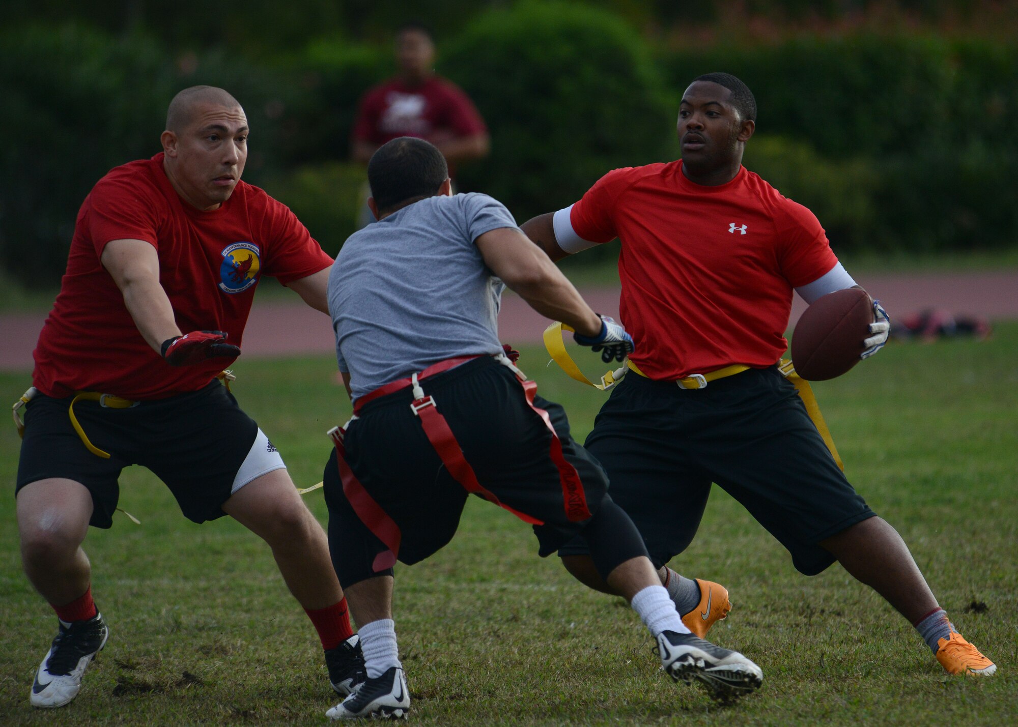 U.S. Air Force Airmen assigned to the 31st Maintenance Squadron and 31st Communications Squadron compete against each other during an intramural flag football game, Sept. 24, 2015, at Aviano Air Base, Italy.  Games are played every Tuesday and Thursday starting at 5:30 p.m. at Freedom Park until Oct. 31. (U.S. Air Force photo by Staff Sgt. Evelyn Chavez/Released)