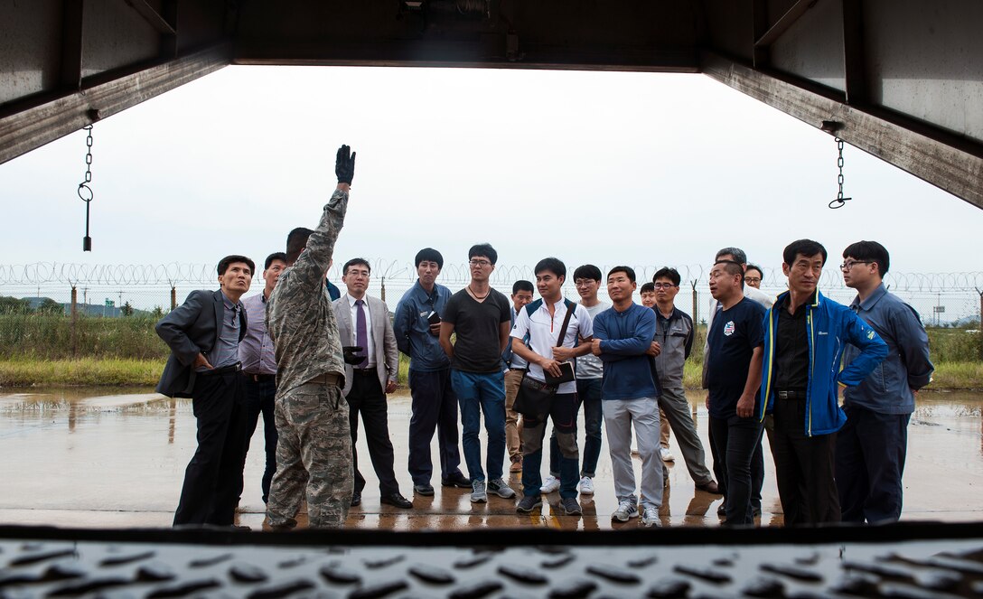 Members of the Gunsan City fire department receive a tour of a live aircraft fire trainer by the 8th Civil Engineer Squadron fire department at Kunsan Air Base, Republic of Korea, Sept. 16, 2015. In addition to the live aircraft fire trainer, the Gunsan City fire department received a tour of the station and engaged the Airmen to ask questions. (U.S. Air Force photo by Staff Sgt. Nick Wilson/Released)