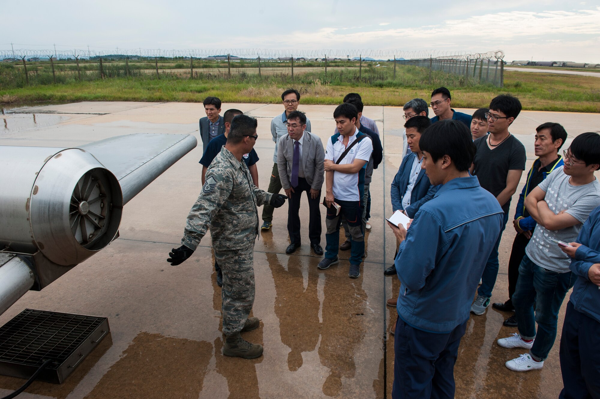 Members of the Gunsan City fire department receive a tour of a live aircraft fire trainer by the 8th Civil Engineer Squadron fire department at Kunsan Air Base, Republic of Korea, Sept. 16, 2015. Members of the Gunsan City fire department visited the fire department to get a tour of the building, meet the Airmen and learn about their equipment. (U.S. Air Force photo by Staff Sgt. Nick Wilson/Released)