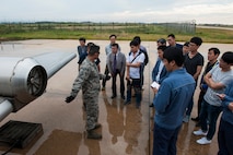 Members of the Gunsan City fire department receive a tour of a live aircraft fire trainer by the 8th Civil Engineer Squadron fire department at Kunsan Air Base, Republic of Korea, Sept. 16, 2015. Members of the Gunsan City fire department visited the fire department to get a tour of the building, meet the Airmen and learn about their equipment. (U.S. Air Force photo by Staff Sgt. Nick Wilson/Released)