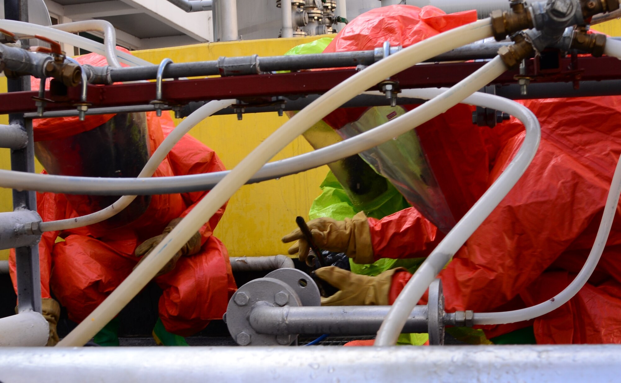 Senior Airman Paul Byous, 51st Civil Engineer Squadron firefighter, stops a simulated hazardous material leak with assistance from two members of the Songtan fire department Sept. 24, 2015, near Songtan, Republic of Korea. More than 15 members of the 51 CES participated in a joint-training exercise with members of the local fire department. (U.S. Air Force photo by Staff Sgt. Benjamin Sutton)