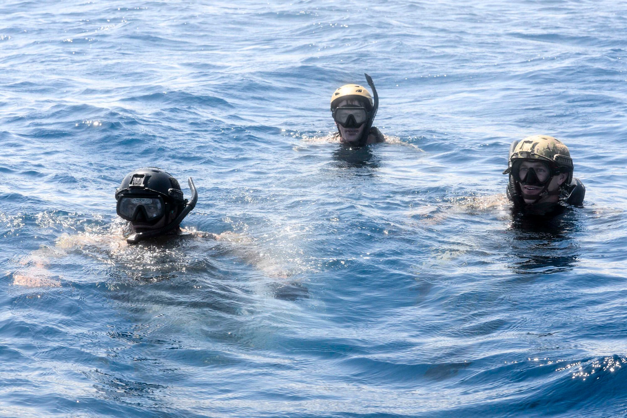 Members of the 320th Special Tactics Squadron from Kadena Air Base wait to be recovered by a U.S. Air Force HH-60G Pave Hawk from the 33rd Rescue Squadron, Sept. 22, 2015, off the west coast of Okinawa, Japan. The Airmen completed various training objectives as part of an amphibious operations exercise, to include alternative insertion extractions, over the horizon navigation on combat rubber raiding crafts and navigational dives. (U.S. Air Force photo by Senior Airman John Linzmeier) 