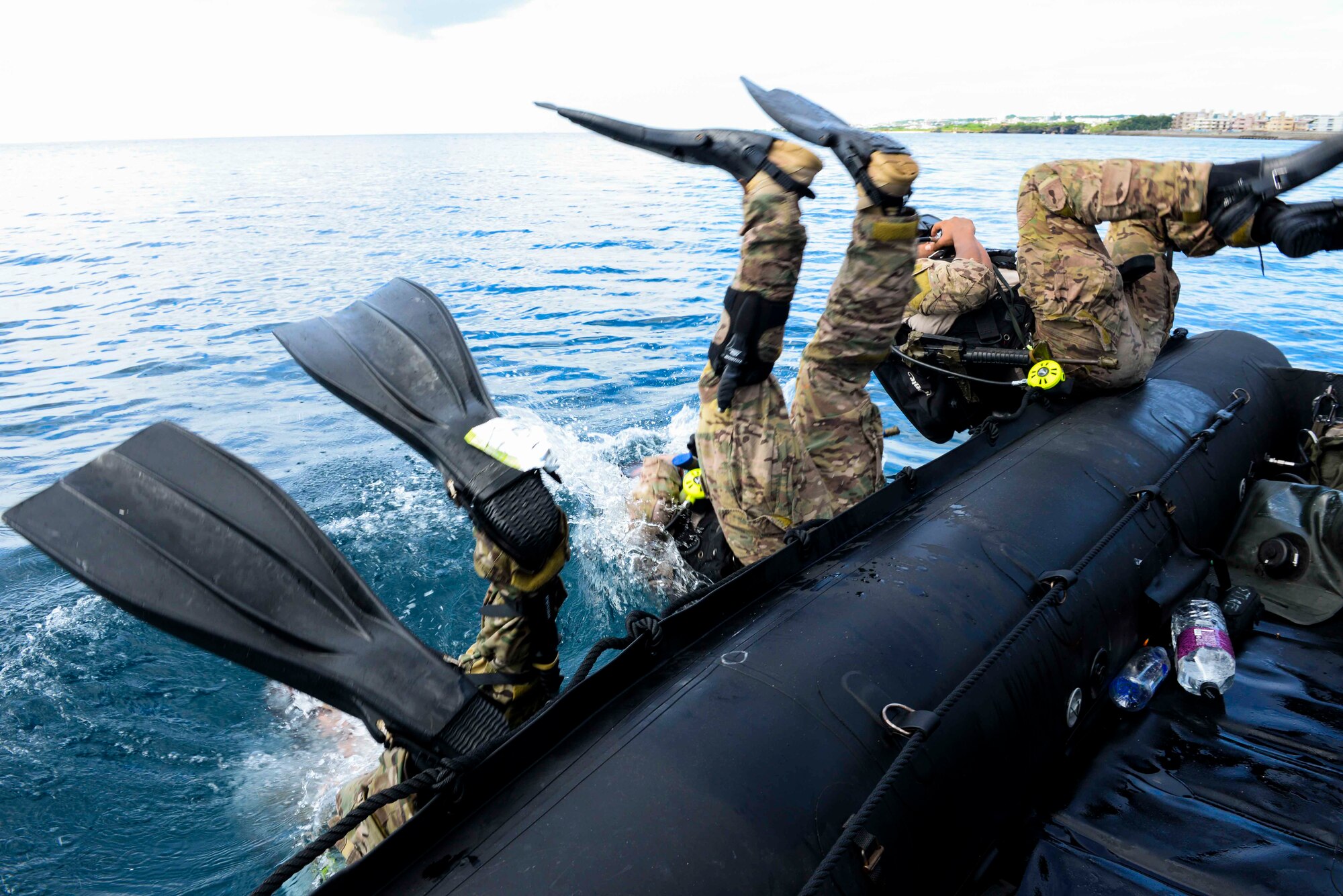 Members of the 320th Special Tactics Squadron from Kadena Air Base submerge into the ocean during an amphibious operations exercise Sept. 22, 2015, off the west coast of Okinawa, Japan. Special tactics Airmen train frequently to sharpen their skillsets in order to support airpower throughout the full spectrum of mission sets U.S. Special Operations Command undertakes. (U.S. Air Force photo by Senior Airman John Linzmeier)