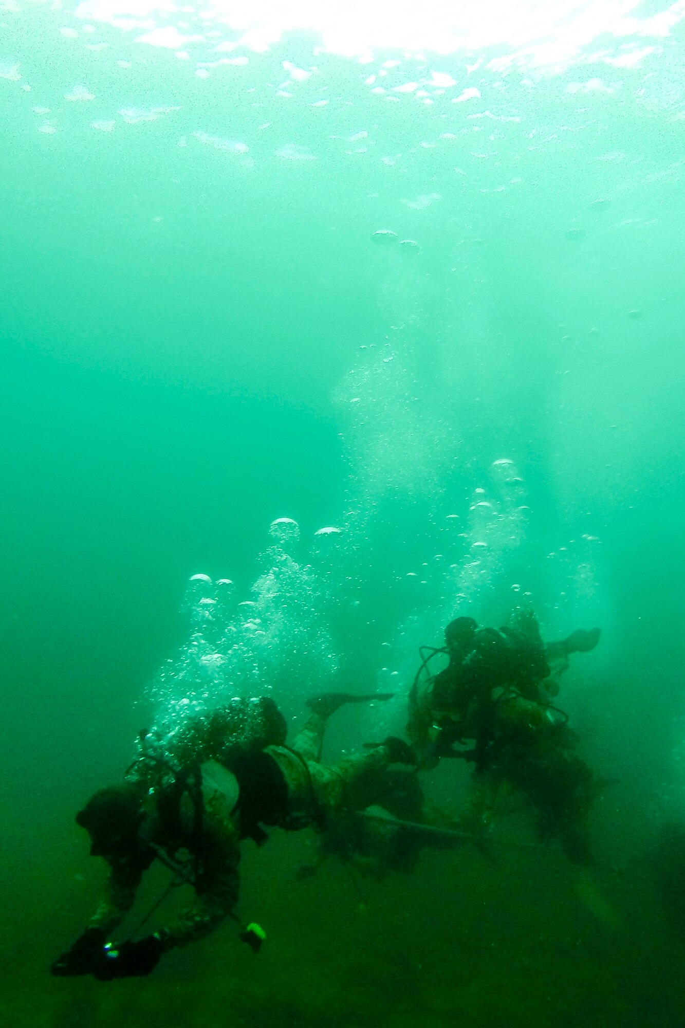 U.S. Air Force combat control Airmen from the 320th Special Tactics Squadron, Kadena Air Base, perform an open-circuit navigation dive during an amphibious operations exercise Sept. 22, 2015, off the West Coast of Okinawa, Japan. Special tactics team Airmen are organized, trained and equipped to conduct special operations core tasks during high-risk combat operations. (Courtesy photo)