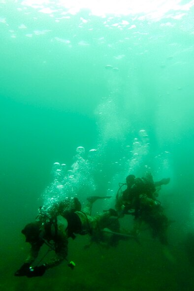 U.S. Air Force combat control Airmen from the 320th Special Tactics Squadron, Kadena Air Base, perform an open-circuit navigation dive during an amphibious operations exercise Sept. 22, 2015, off the West Coast of Okinawa, Japan. Special tactics team Airmen are organized, trained and equipped to conduct special operations core tasks during high-risk combat operations. (Courtesy photo)