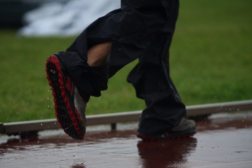 U.S. Air Force Capt. Michael Gruber, 35th Communications Squadron director of operations, runs in a water-drenched track at Misawa Air Base, Japan, Sept. 18, 2015. For half of the entire duration of his 24-hour run, Gruber was faced with an onslaught of rain. (U.S. Air Force photo by Senior Airman Jose L. Hernandez-Domitilo)