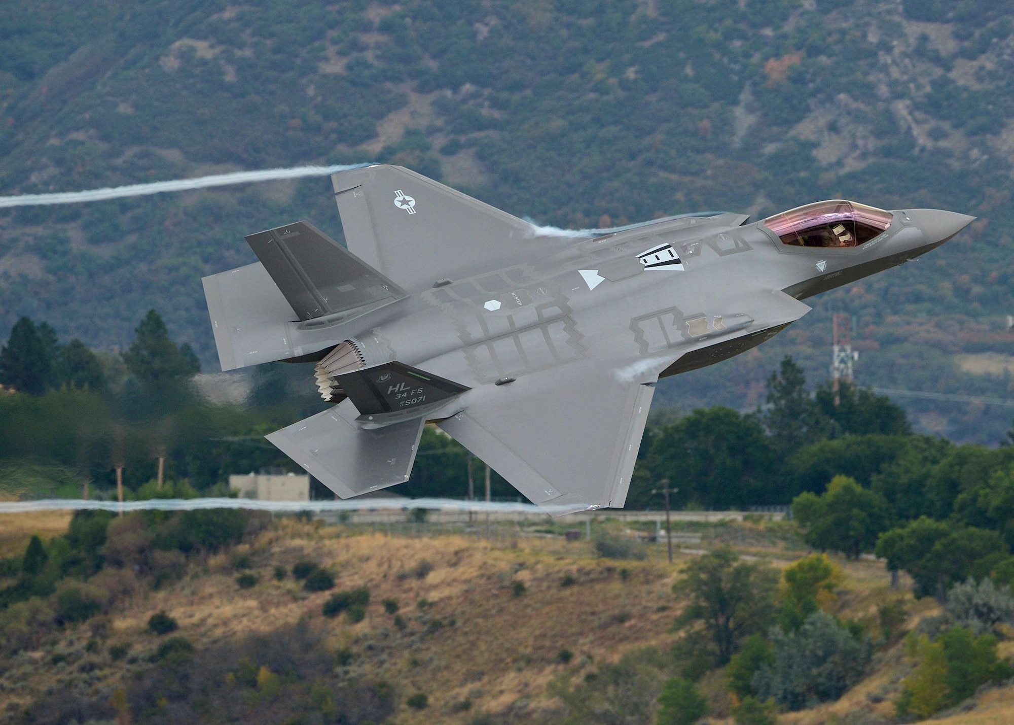 Lt. Col. George Watkins, the 34th Fighter Squadron commander, flies a combat-coded F-35A Lightning II aircraft past the control tower at Hill Air Force Base, Utah, Sept. 17, 2015. During the sortie, the base’s first, Watkins conducted mission qualification training focusing on weapons employment, range familiarization and mission system proficiency. (U.S. Air Force photo/Alex R. Lloyd)