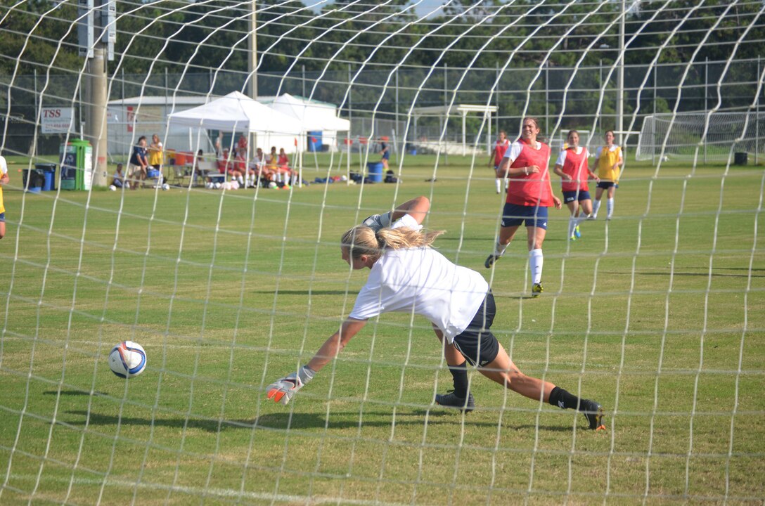 Alyson Gleason lunges in an attempt to stop a goal by Kate Herren during women's Armed Forces soccer camp last week at MacDill Air Force Base, Fla. Gleason is headed to compete for the USA at the Military World Games in Korea next week. (Photo by Kevin Davalos)