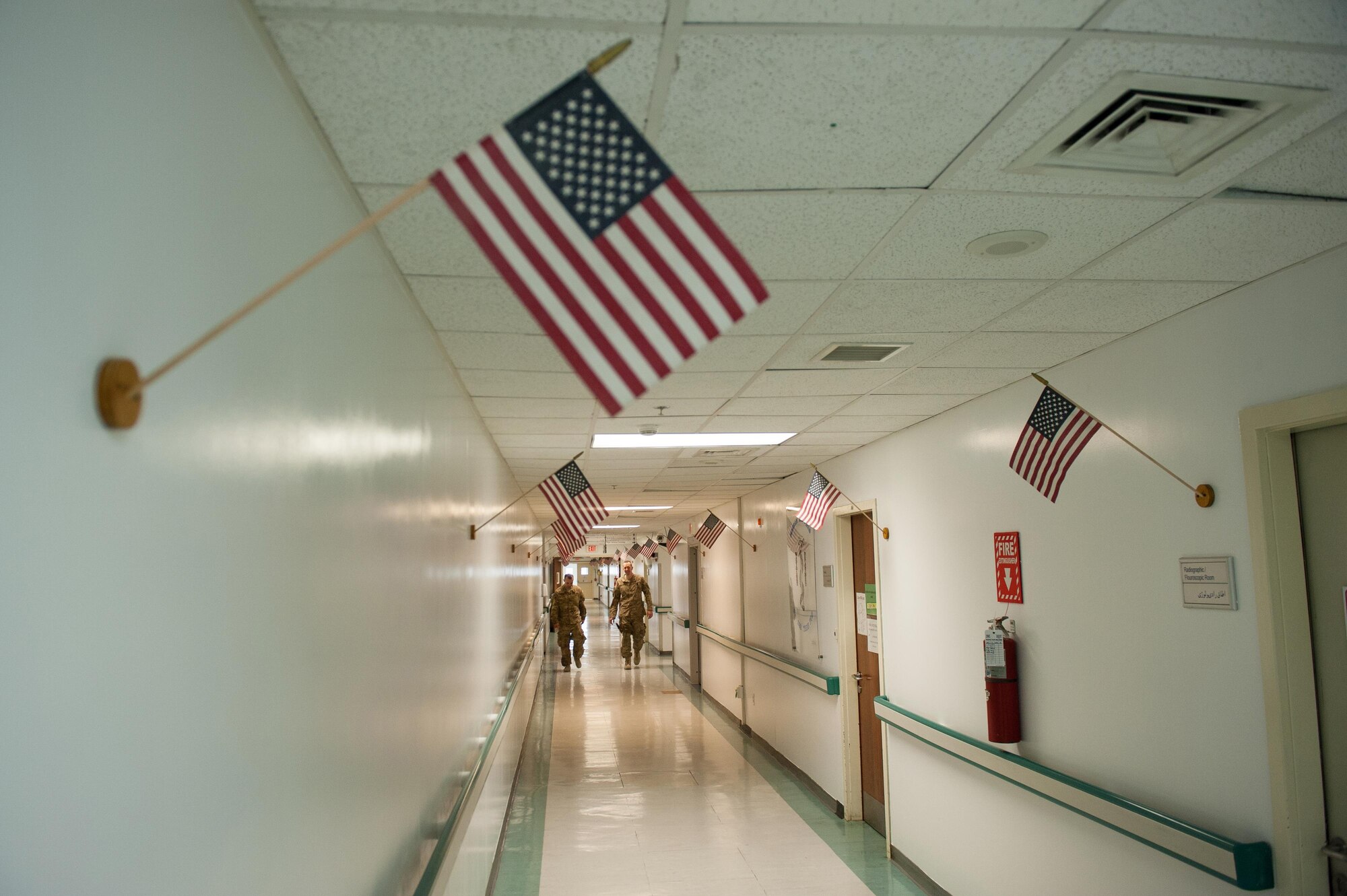 U.S. Air Force Tech. Sgt. Scott Hatch, left, and Maj. Thomas Naughton, both assigned to the 455th Expeditionary Medical Group, walk through the Craig Joint Theater Hospital at Bagram Airfield, Afghanistan, Sept. 24, 2015. (U.S. Air Force photo by Tech. Sgt. Joseph Swafford/Released)