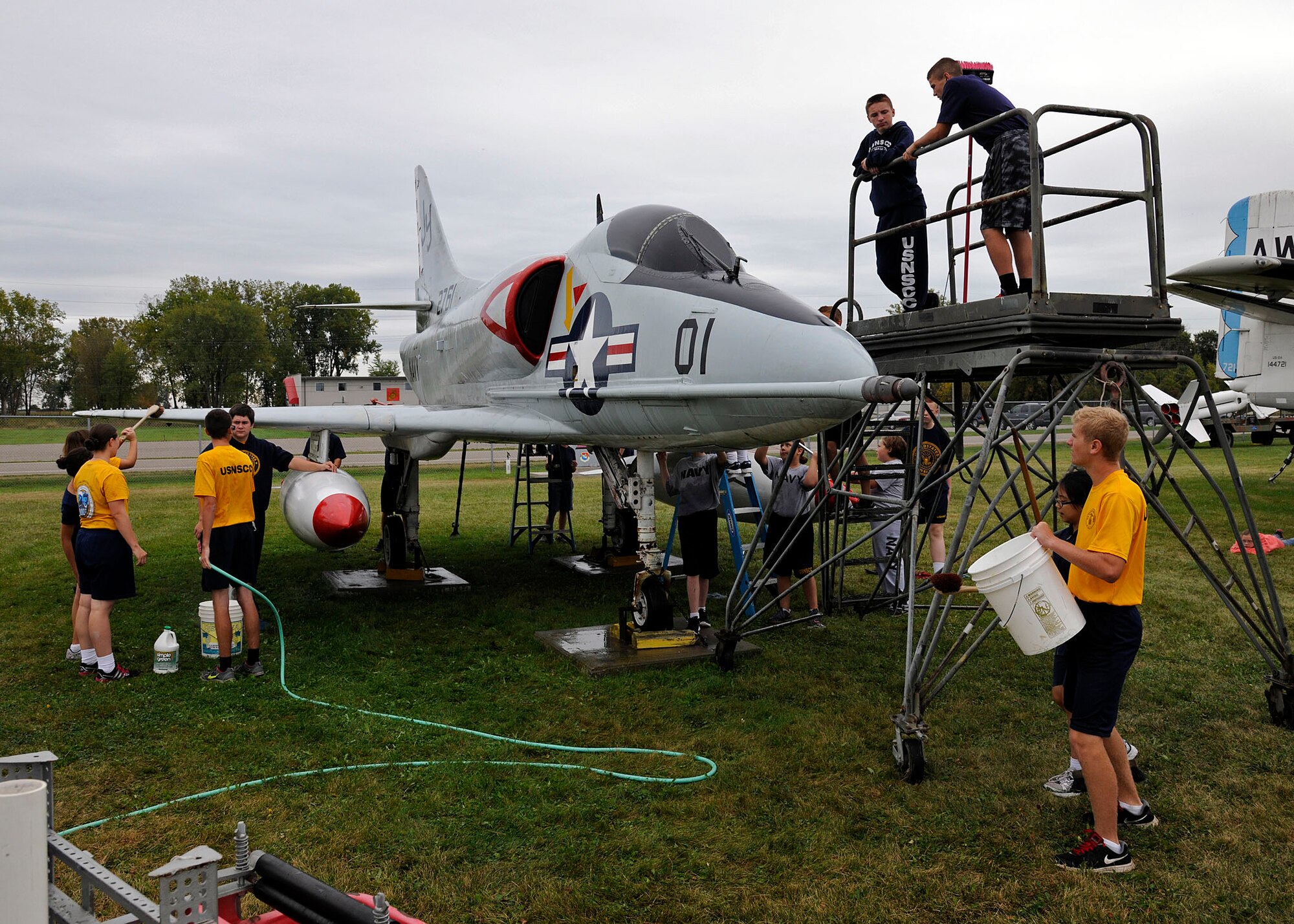 Sea Cadets from the Tomcat squadron, wash an A-4B Skyhawk at the Selfridge
Military Air Museum on Selfridge Air National Guard Base, Michigan, Sept.
27, 2015. The Tomcat squadron recently adopted the A-4B Skyhawk and helps
keep the aircraft in top shape. The Skyhawk is a single seat carrier-capable
attack aircraft developed for the United States Navy. The Skyhawk was
operated at Selfridge ANGB from 1969 to 1973. (U.S. Air National Guard photo
by Senior Airman Ryan Zeski/Released)
