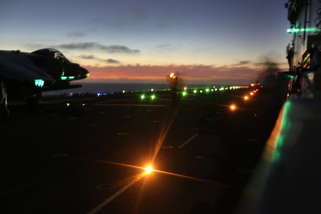 U.S. Marines and sailors conduct night flight operations with AB-8B Harriers on the flight deck of the USS Boxer during Integration Training in the Pacific Ocean, Sept. 26, 2015. The Marines are assigned to Medium Tiltrotor Squadron 166 Reinforced, 2nd Battalion Landing Team, 13th Marine Expeditionary Unit. The exercise is the first at sea for the newly integrated 13th MEU to prepare all aspects into their forward deployed roles including the air combat element. U.S. Marine Corps photo by Sgt. Paris Capers