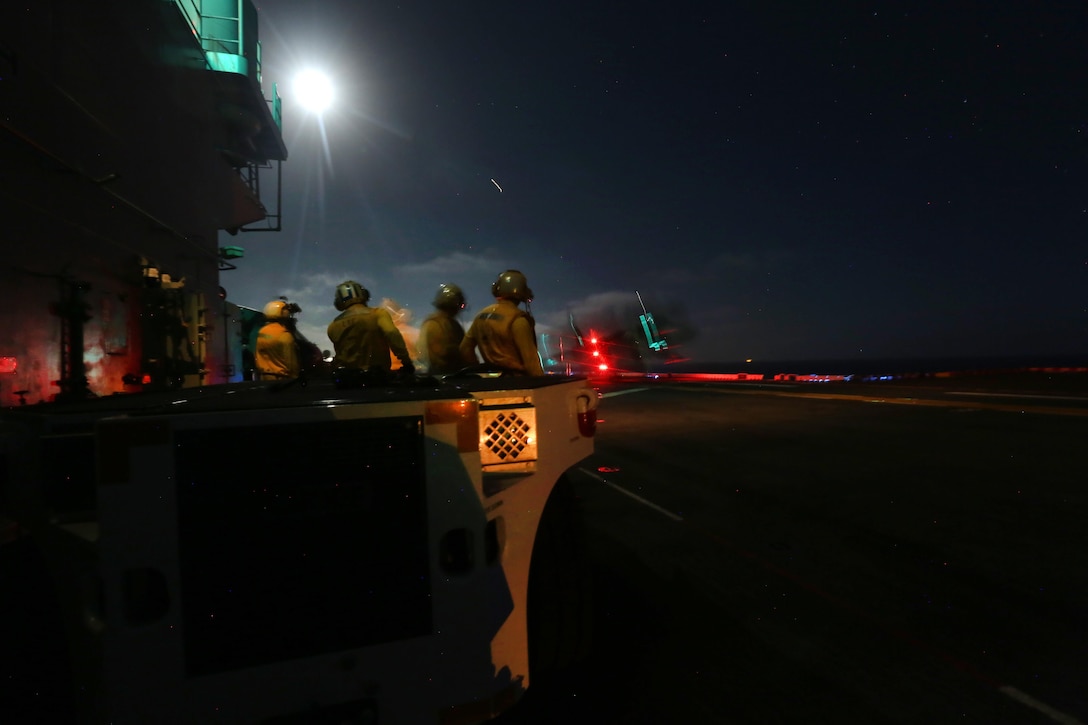 U.S. Marines and sailors conduct night flight operations with AB-8B Harriers on the flight deck of the USS Boxer during Integration Training in the Pacific Ocean, Sept. 26, 2015. U.S. Marine Corps photo by Sgt. Paris Capers