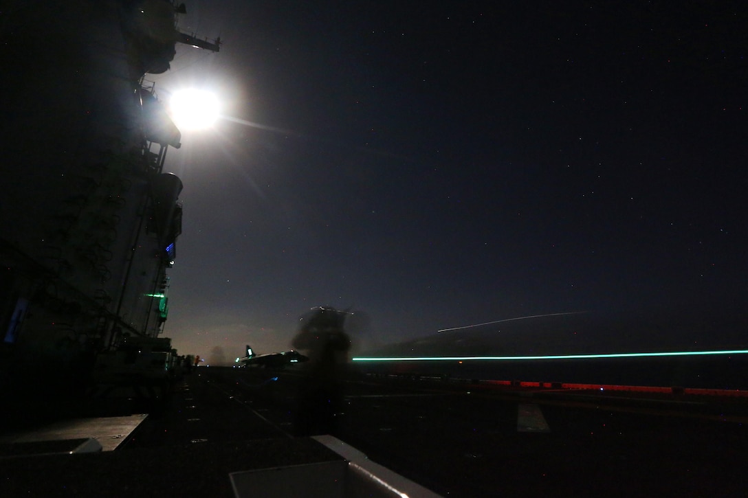 U.S. Marines and sailors conduct night flight operations with AB-8B Harriers on the flight deck of the USS Boxer during Integration Training in the Pacific Ocean, Sept. 26, 2015. U.S. Marine Corps photo by Sgt. Paris Capers