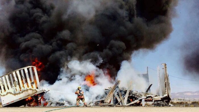 A firefighter with Marine Corps Logistics Base Barstow, California, battles a structure fire as part of a mutual aid response to the Butte Fire in Northern California. More than 3,300 fire crews from all over the state assisted in containing the huge blaze.