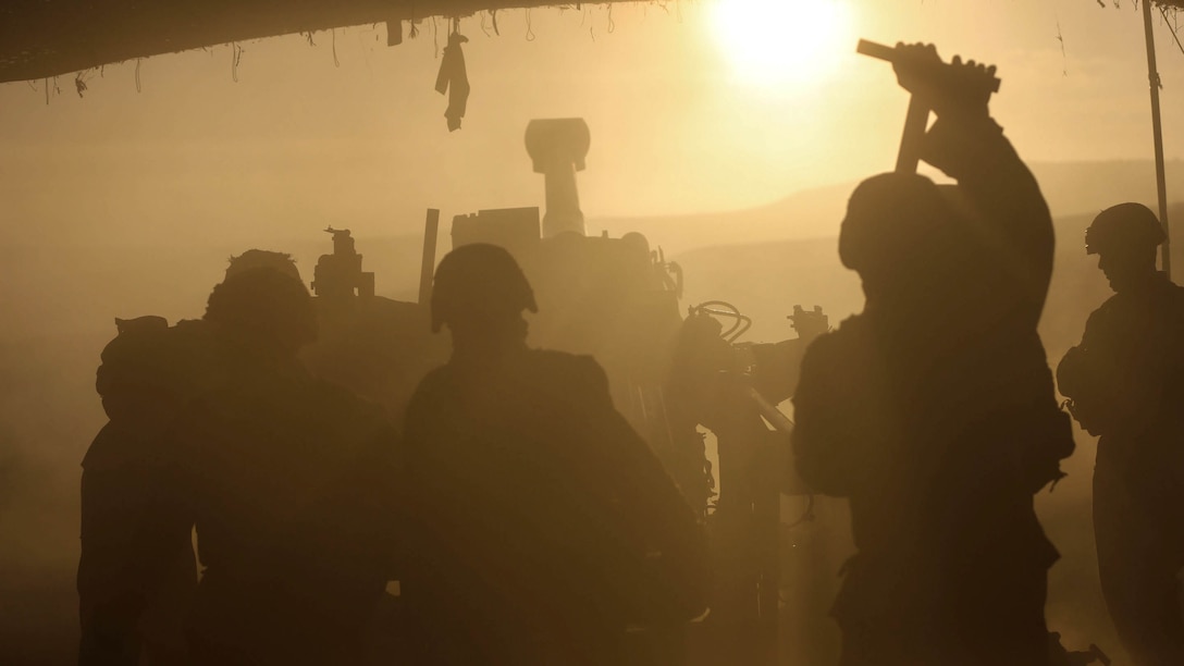 Battery B, 1st Battalion, 11th Marine Regiment works  through the debris and fog in order to fire rounds during Supporting Arms Coordination Center Exercise on San Clemente Island, Calif., Sept. 25, 2015. The exercise is the first the Marines and Sailors will work together at sea as they prepare for deployment to the Pacific and Central Command areas of responsibility in early 2016. 