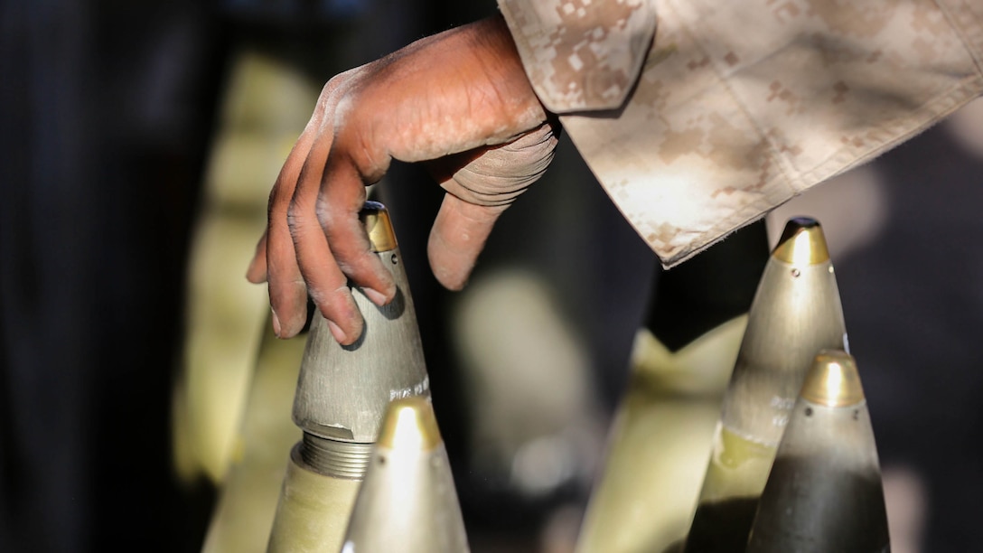 Lance Cpl. Shaheed G. Johnson, a cannoneer with Battery B, 1st Battalion, 11th Marine Regiment, secures high explosive charges to their shells during Supporting Arms Coordination Center Exercise on San Clemente Island, Calif., Sept. 25, 2015. The exercise is the first the Marines and Sailors will work together at sea as they prepare for deployment to the Pacific and Central Command areas of responsibility in early 2016.