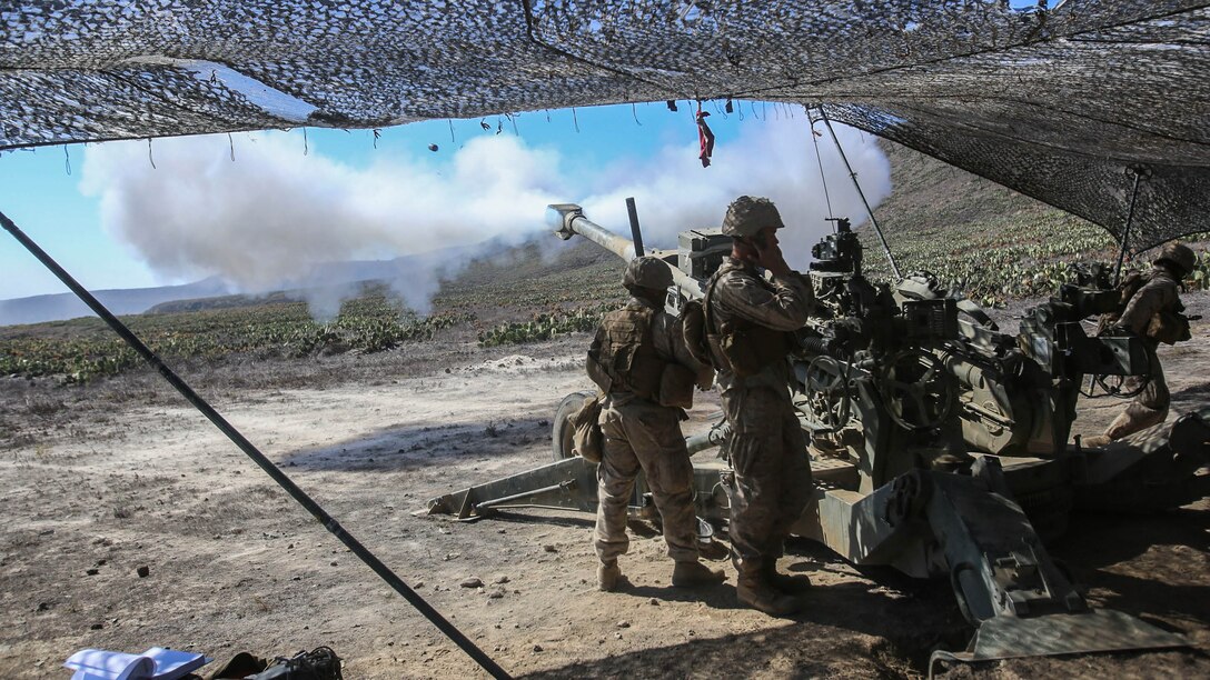 Marines from Battery B, 1st Battalion, 11th Marine Regiment, fire rounds down range in support of Supporting Arms Coordination Center Exercise on San Clemente Island, Calif., Sept. 25, 2015. The exercise is the first the Marines and Sailors will work together at sea as they prepare for deployment to the Pacific and Central Command areas of responsibility in early 2016.