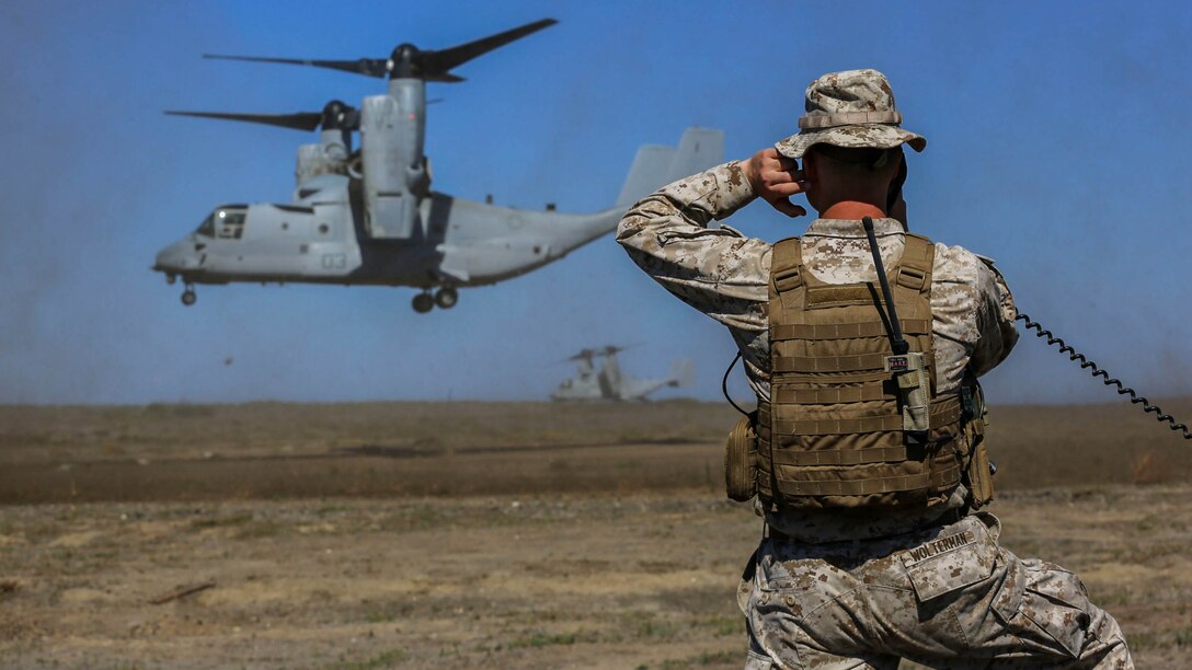 Captain Sean Wolterman, the air officer for the 13th Marine Expeditionary Unit, coordinates the landing of a MV-22 Osprey onto San Clemente Island, Calif., Sept. 24, 2015. The exercise is the first the Marines and Sailors will work together at sea as they prepare for deployment to the Pacific and Central Command areas of responsibility in early 2016. 