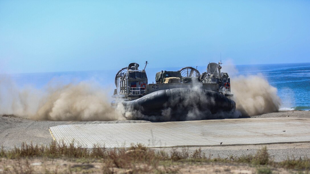 A Landing Craft Air Cushion splashes onto San Clemente Island, Calif., during Supporting Arms Coordination Center Exercise on Sept. 24, 2015. This exercise is the first the Marines and Sailors will work together at sea as they prepare for deployment to the Pacific and Central Command areas of responsibility in early 2016. 