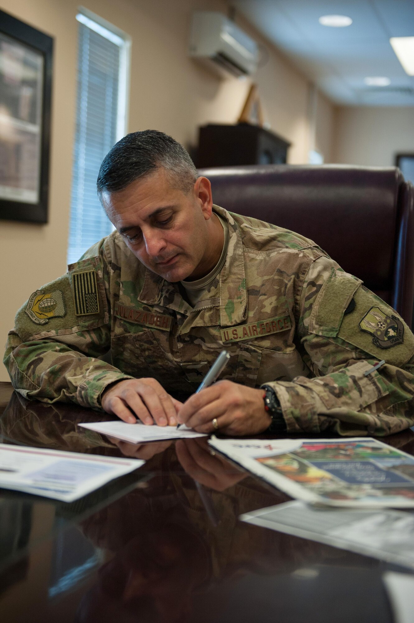 U.S. Air Force Brig. Gen. Dave Julazadeh, 455th Air Expeditionary Wing commander, fills out a donation form for the Combined Federal Campaign-Overseas at Bagram Airfield, Afghanistan, Sept. 28, 2015. The CFC is the official workplace giving campaign of the federal government. (U.S. Air Force photo by Tech. Sgt. Joseph Swafford/Released)