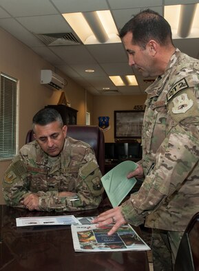 U.S. Air Force Senior Master Sgt. Matthew Messner, 455th Expeditionary Logistics Squadron, goes over the Combined Federal Campaign-Overseas donation form with Brig. Gen. Dave Julazadeh, 455th Air Expeditionary Wing commander, at Bagram Airfield, Afghanistan, Sept. 28, 2015. The CFC is the official workplace giving campaign of the federal government. (U.S. Air Force photo by Tech. Sgt. Joseph Swafford/Released)