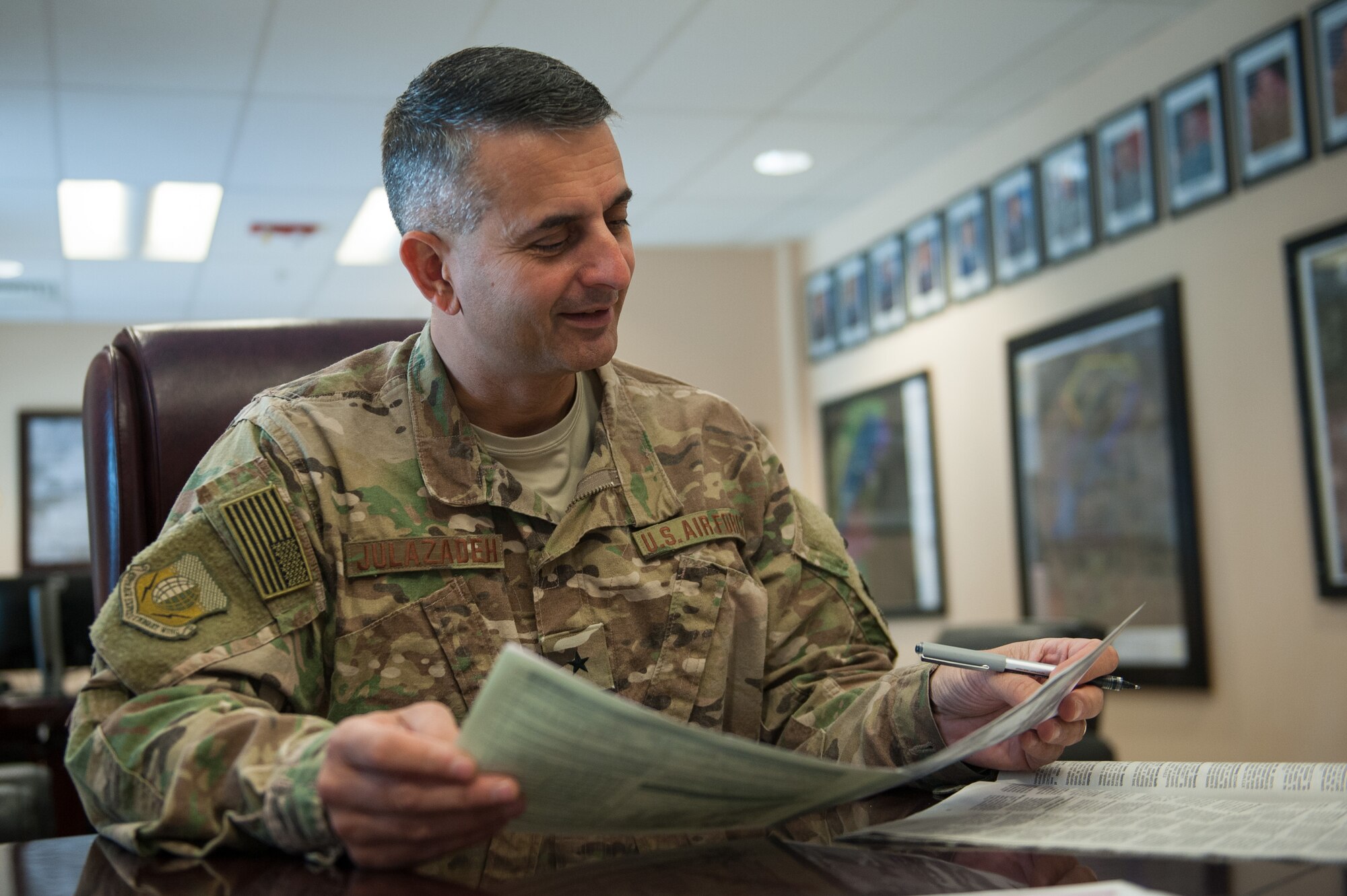 U.S. Air Force Brig. Gen. Dave Julazadeh, 455th Air Expeditionary Wing commander, looks over the donation pamphlet for the Combined Federal Campaign-Overseas at Bagram Airfield, Afghanistan, Sept. 28, 2015. The CFC is the official workplace giving campaign of the federal government. (U.S. Air Force photo by Tech. Sgt. Joseph Swafford/Released)