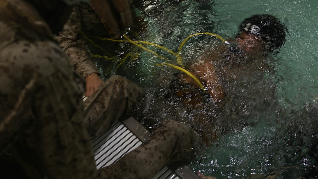 A Marine with Echo Company, Battalion Landing Team, 2nd Battalion, 6th Marine Regiment, submerges underwater while wearing a supplemental emergency breathing device at Marine Corps Base Camp Lejeune, North Carolina, Sept. 22, 2015. The company participated in the submerged vehicle egress training to gain confidence in their abilities to safely exit a sinking amphibious assault vehicle in preparation for their upcoming deployment with the 26th Marine Expeditionary Unit. 