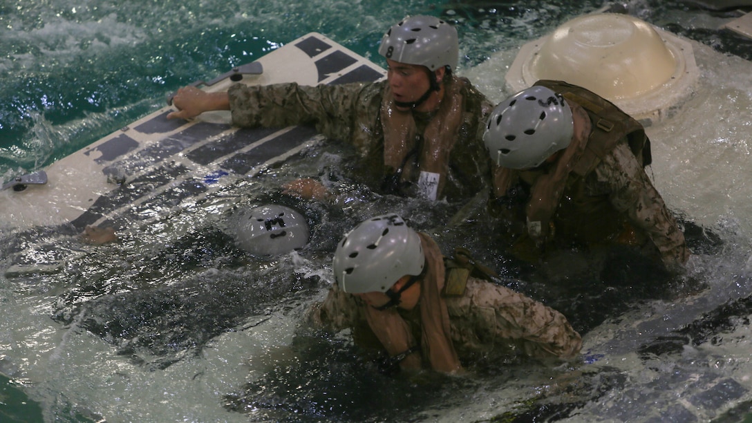 Marines with Echo Company, Battalion Landing Team, 2nd Battalion, 6th Marine Regiment, emerge from a simulated amphibious assault vehicle at Marine Corps Base Camp Lejeune, North Carolina, Sept. 22, 2015. The company participated in the submerged vehicle egress training in order to gain confidence in their abilities to safely exit a sinking amphibious assault vehicle in preparation for their upcoming deployment with the 26th Marine Expeditionary Unit. 