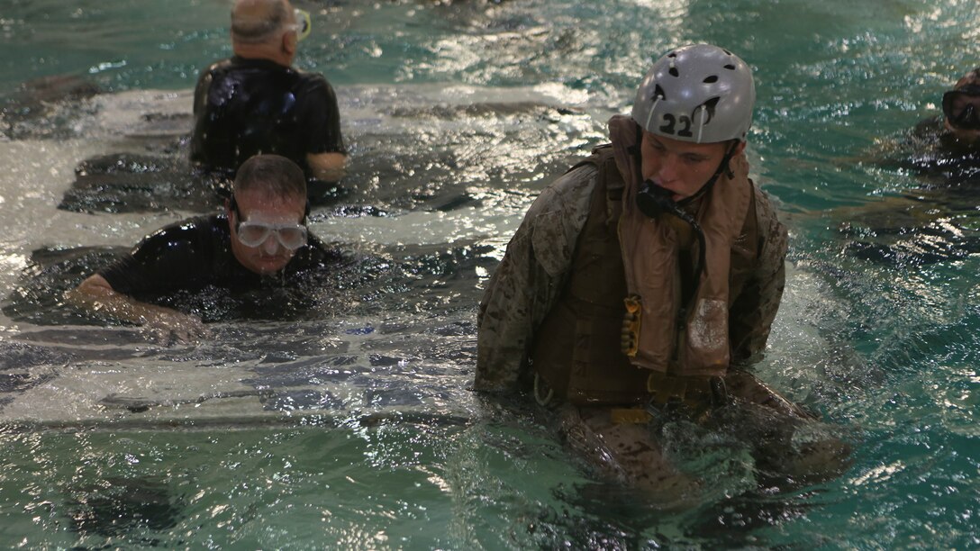 Marines with Echo Company, Battalion Landing Team, 2nd Battalion, 6th Marine Regiment, emerge from a simulated amphibious assault vehicle at Marine Corps Base Camp Lejeune, North Carolina, Sept. 22, 2015. The company participated in the submerged vehicle egress training to gain confidence in their abilities to safely exit a sinking amphibious assault vehicle in preparation for their upcoming deployment with the 26th Marine Expeditionary Unit. 